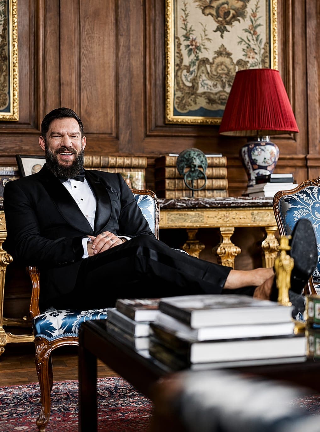 A client in black tie seated in a panelled drawing room