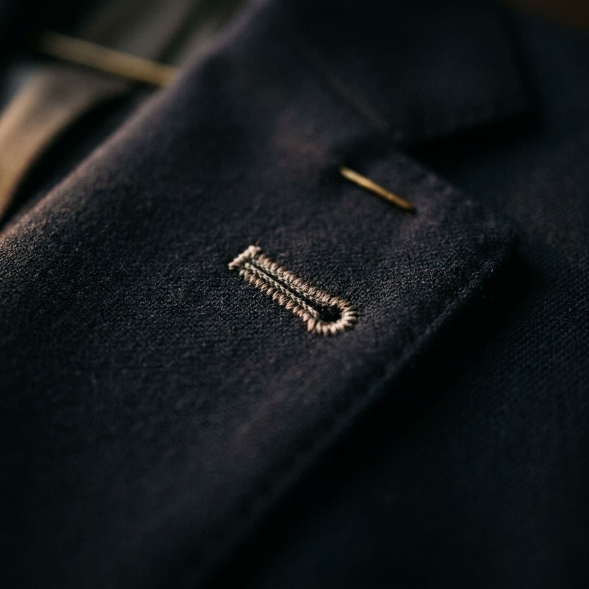 A hand-sewn Milanese buttonhole worked in silk on a navy suit lapel
